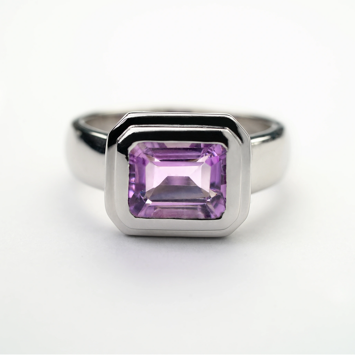 Sterling silver amethyst gemstone ring with a rectangular-cut purple stone in a modern bezel setting
