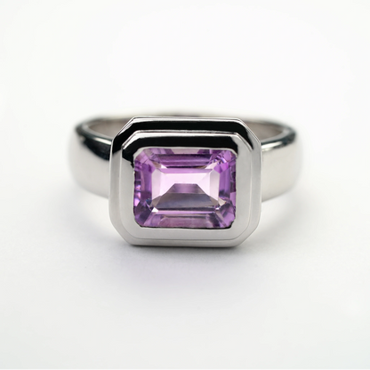 Sterling silver amethyst gemstone ring with a rectangular-cut purple stone in a modern bezel setting
