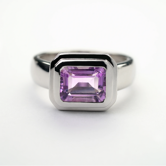 Sterling silver amethyst gemstone ring with a rectangular-cut purple stone in a modern bezel setting
